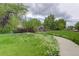 Picturesque park landscape with a small walking bridge surrounded by flowers and greenery at 7552 Garland St, Arvada, CO 80005