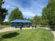 A covered pavilion with picnic tables and a grill at a community park at 7552 Garland St, Arvada, CO 80005