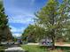 Community playground with swings, slides and play equipment in a park setting at 7552 Garland St, Arvada, CO 80005
