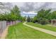 A well-manicured walking path surrounded by lush greenery and mature trees at 7552 Garland St, Arvada, CO 80005