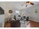 Sunlit living room featuring hardwood floors, neutral decor, large windows, and comfortable seating at 3709 Ames St, Wheat Ridge, CO 80212