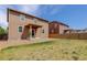 View of backyard featuring well maintained lawn, brown siding, and wood fence at 467 S 36Th Ave, Brighton, CO 80601