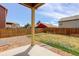 View of a fenced-in backyard with grass and rock landscaping, patio and other houses at 467 S 36Th Ave, Brighton, CO 80601