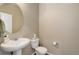 Half bathroom featuring a pedestal sink, toilet, and a decorative mirror at 467 S 36Th Ave, Brighton, CO 80601