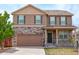 Two-story home with stone accents, shutters, covered porch and attached two car garage at 467 S 36Th Ave, Brighton, CO 80601