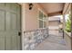 Covered front porch with stone base, siding, and view of the neighboring home at 467 S 36Th Ave, Brighton, CO 80601