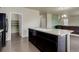 Kitchen featuring dark cabinets, light countertops, and a center island with a sink at 467 S 36Th Ave, Brighton, CO 80601