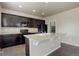 Kitchen featuring dark cabinets, light countertops, and a center island with a sink at 467 S 36Th Ave, Brighton, CO 80601