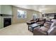 Open concept living room and kitchen with fireplace and comfortable leather seating at 467 S 36Th Ave, Brighton, CO 80601