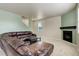 Comfortable living room with fireplace, staircase, and plush carpeting at 467 S 36Th Ave, Brighton, CO 80601