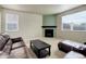 Bright living room with fireplace, leather seating, and large windows at 467 S 36Th Ave, Brighton, CO 80601