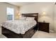 Cozy main bedroom featuring a wooden bed frame, side tables, and a bright window at 467 S 36Th Ave, Brighton, CO 80601