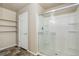 Shower with sliding glass door and tiled walls next to the shelves at 467 S 36Th Ave, Brighton, CO 80601