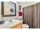 Well-maintained bathroom features a framed mirror and shower with a brown curtain at 11746 Elizabeth Cir, Thornton, CO 80233