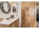 Bathroom vanity features a white countertop and wooden cabinets at 11746 Elizabeth Cir, Thornton, CO 80233
