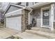 Charming entrance with decorative accents, stone pillar and gray siding details at 11746 Elizabeth Cir, Thornton, CO 80233