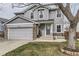 Charming two-story home with stone accents, attached garage, and well-manicured front lawn at 11746 Elizabeth Cir, Thornton, CO 80233