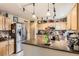 Spacious kitchen featuring stainless steel appliances, wood cabinetry, and countertops at 11746 Elizabeth Cir, Thornton, CO 80233