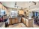 Bright kitchen featuring wood cabinets, modern appliances, and an island with countertops at 11746 Elizabeth Cir, Thornton, CO 80233