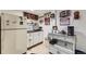 Basement kitchenette with white cabinets, black countertops and beverage cooler at 11746 Elizabeth Cir, Thornton, CO 80233