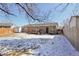 This property boasts a spacious backyard, complete with a wooden deck and ample room for recreation and relaxation at 6393 S Johnson St, Littleton, CO 80123