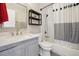 Updated bathroom with a gray vanity and shower with white tile at 6393 S Johnson St, Littleton, CO 80123