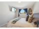 Bedroom featuring a window with blue curtains, a queen bed and TV at 6393 S Johnson St, Littleton, CO 80123