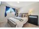 Bedroom featuring a window with bright blue curtains and a queen bed at 6393 S Johnson St, Littleton, CO 80123