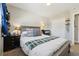 Bedroom featuring a queen bed, carpet and a closet with sliding doors at 6393 S Johnson St, Littleton, CO 80123
