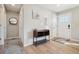 Inviting entryway with sleek wood floors, white walls, a small wooden console table, and front door at 6393 S Johnson St, Littleton, CO 80123
