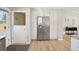 Bright kitchen with a stainless steel refrigerator and wood flooring at 6393 S Johnson St, Littleton, CO 80123
