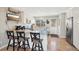 Bright kitchen with a breakfast bar, granite countertops, stainless steel appliances, and a door to the backyard at 6393 S Johnson St, Littleton, CO 80123