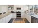 Modern kitchen featuring stainless steel appliances, granite countertops, and bright white cabinets at 6393 S Johnson St, Littleton, CO 80123
