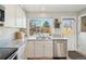 Updated kitchen with granite countertops, stainless steel dishwasher, and a window above the sink at 6393 S Johnson St, Littleton, CO 80123