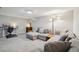 Spacious living room featuring a comfortable sectional sofa, workspace, and neutral tones at 6393 S Johnson St, Littleton, CO 80123