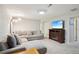 Living room featuring a sectional sofa, carpeting and a fireplace with TV at 6393 S Johnson St, Littleton, CO 80123