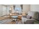 Cozy living room with a large picture window, plush seating, and neutral decor at 6393 S Johnson St, Littleton, CO 80123