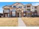 Well-maintained condominium featuring brick accents, multiple balconies, and a welcoming walkway at 5735 N Genoa Way # 11-205, Aurora, CO 80019