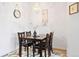 Dining room features a chandelier, seating for four, with wood flooring at 5735 N Genoa Way # 11-205, Aurora, CO 80019