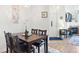 Dining room features a chandelier, seating for four, with wood flooring and fireplace at 5735 N Genoa Way # 11-205, Aurora, CO 80019