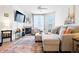 Cozy living room featuring a fireplace, plush seating, and ample natural light, creating a relaxing atmosphere at 5735 N Genoa Way # 11-205, Aurora, CO 80019