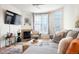 Comfortable living room featuring a fireplace, plush seating, and ample natural light, creating a relaxing atmosphere at 5735 N Genoa Way # 11-205, Aurora, CO 80019