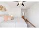 Bright main bedroom features a ceiling fan, neutral decor with attached bathroom at 5735 N Genoa Way # 11-205, Aurora, CO 80019