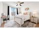 Bright main bedroom with a ceiling fan, desk, neutral decor and plush rug at 5735 N Genoa Way # 11-205, Aurora, CO 80019