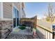 A cozy back patio with a small bench and chairs. A privacy fence encloses the space at 9047 Apache Plume Dr # D, Parker, CO 80134
