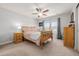 Bright bedroom featuring natural wood furniture, a ceiling fan, and soft natural light at 9047 Apache Plume Dr # D, Parker, CO 80134