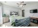 Charming bedroom with a decorative headboard, wooden furniture, and a mounted TV at 9047 Apache Plume Dr # D, Parker, CO 80134