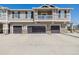 Three car garages and neutral colored siding with stone accents at 9047 Apache Plume Dr # D, Parker, CO 80134