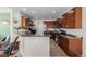An eat-in kitchen showcases dark cabinets, tiled floors, and modern appliances at 9047 Apache Plume Dr # D, Parker, CO 80134