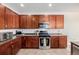 Kitchen featuring sleek, dark cabinets, stainless steel appliances and tile floors at 9047 Apache Plume Dr # D, Parker, CO 80134